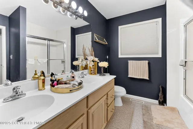 a bathroom with a sink vanity and a mirror