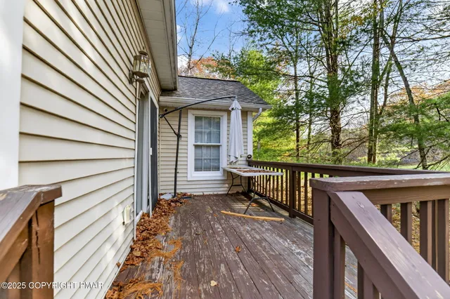 a view of balcony with wooden floor and fence