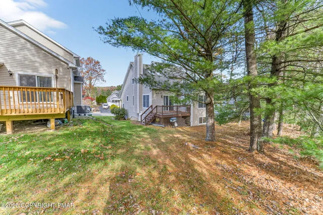 a backyard of a house with a table and chairs