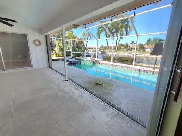 a view of a livingroom with a furniture and chandelier fan