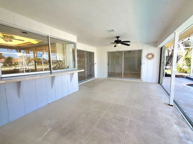 a view of a kitchen with a sink and a large window