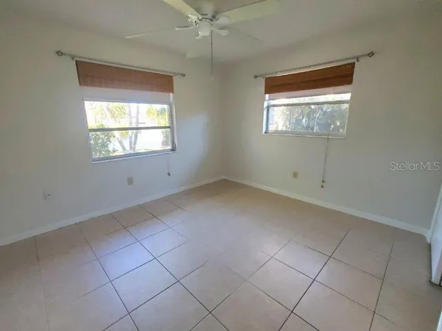 an empty room with windows and closet