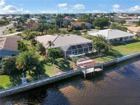 an aerial view of a house with swimming pool patio and outdoor seating