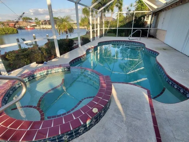 a view of a swimming pool with sitting area