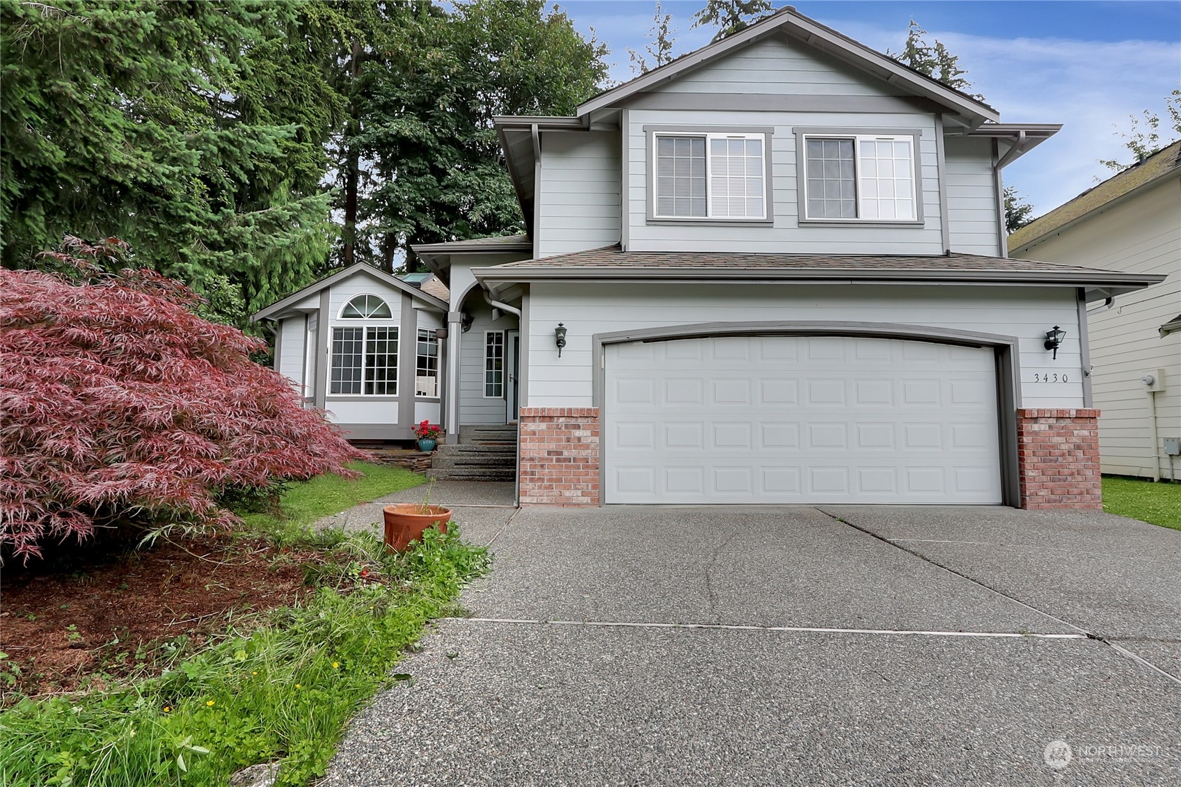 a front view of a house with a yard and garage