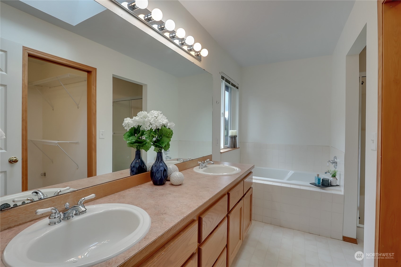 3430 201st Place Southeast Bothell, WA 98012 - Photo 20 of 32 a bathroom with a granite countertop sink a large mirror and a bathtub