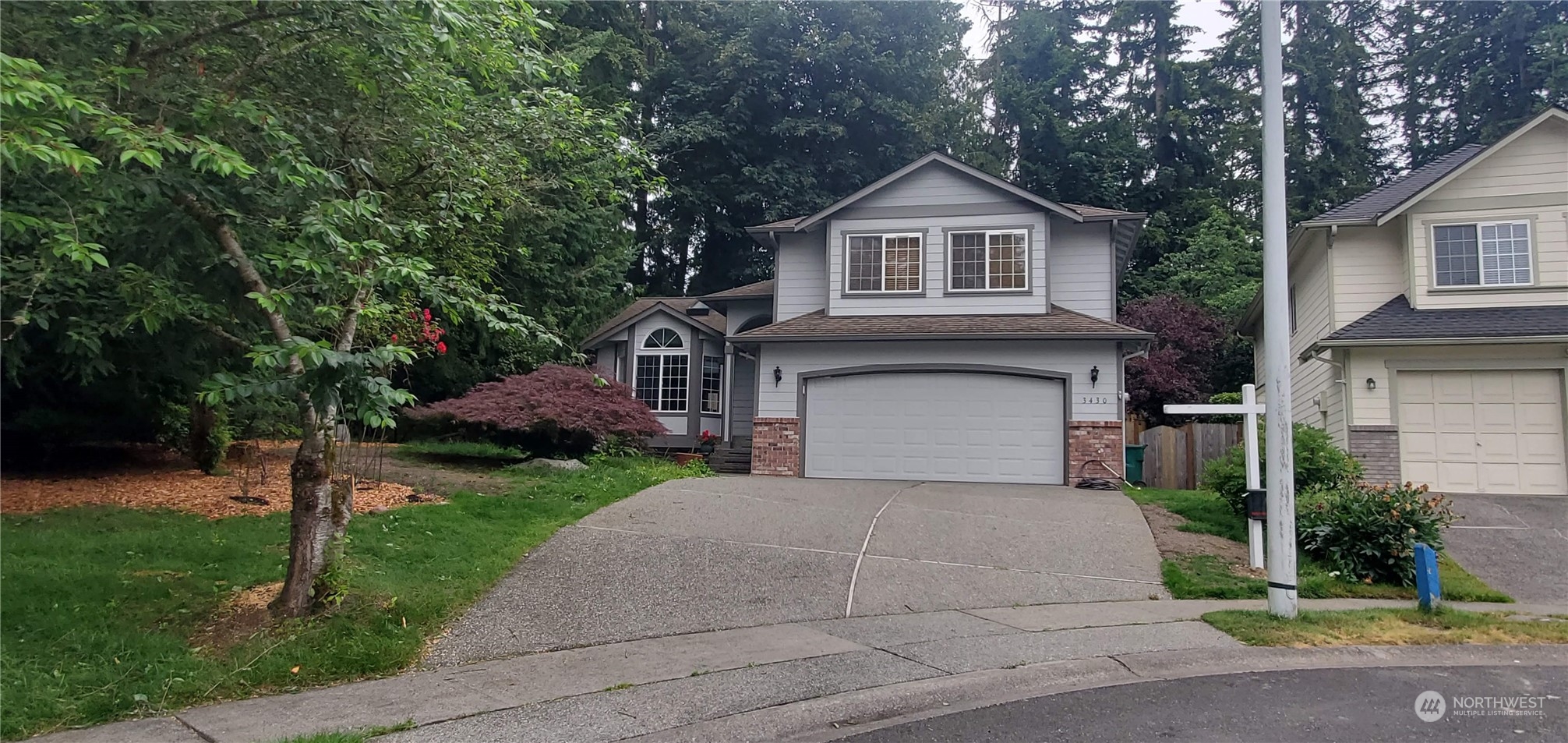 3430 201st Place Southeast Bothell, WA 98012 - Photo 29 of 32 a front view of a house with a yard and garage