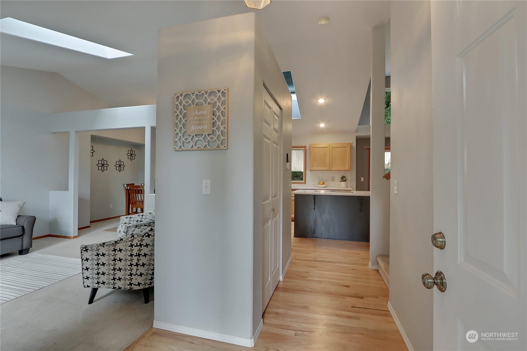 3430 201st Place Southeast Bothell, WA 98012 - Photo 3 of 32 a view of a hallway with wooden floor and living room