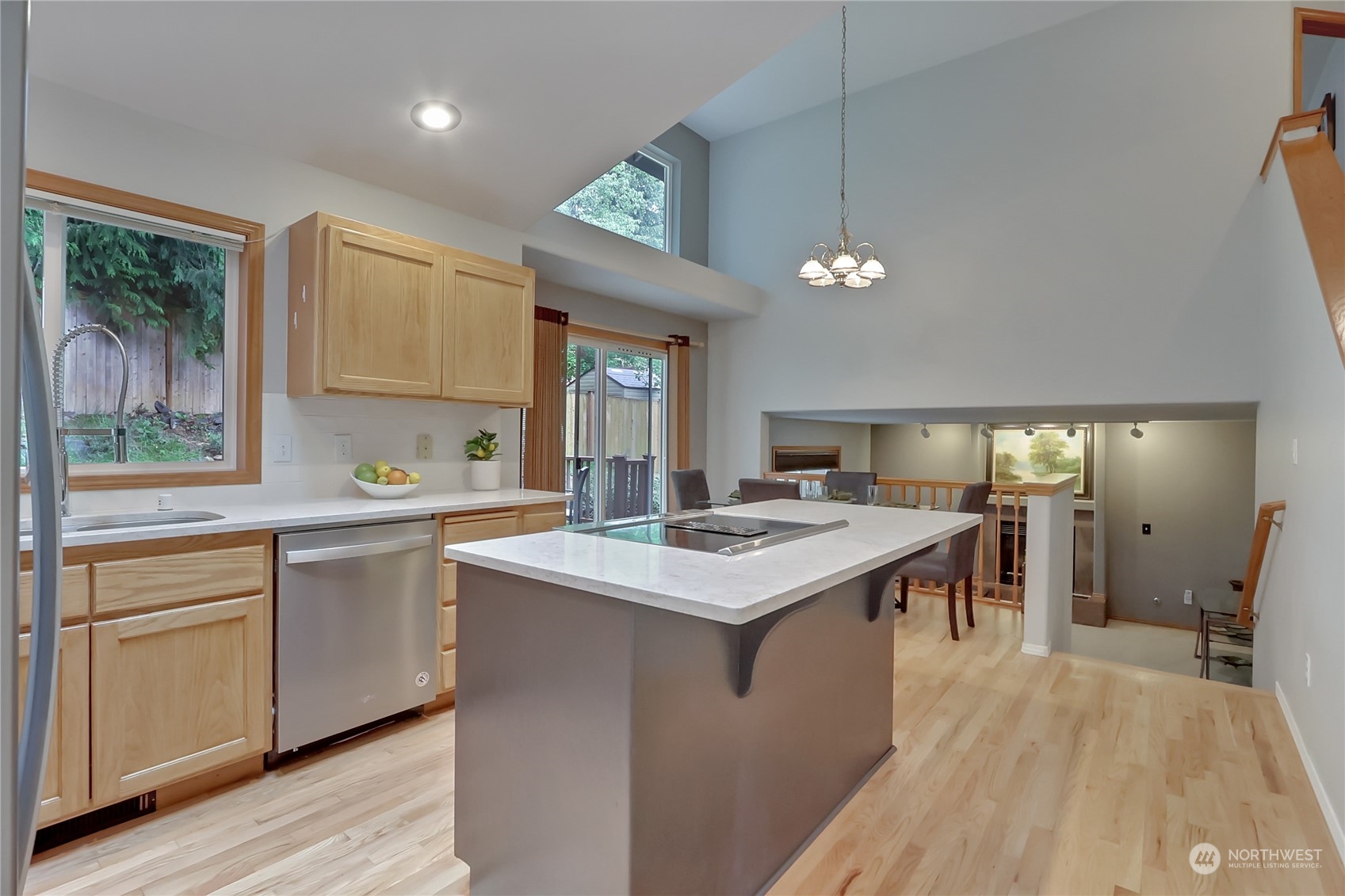 3430 201st Place Southeast Bothell, WA 98012 - Photo 9 of 32 a kitchen with a stove a sink a center island and windows