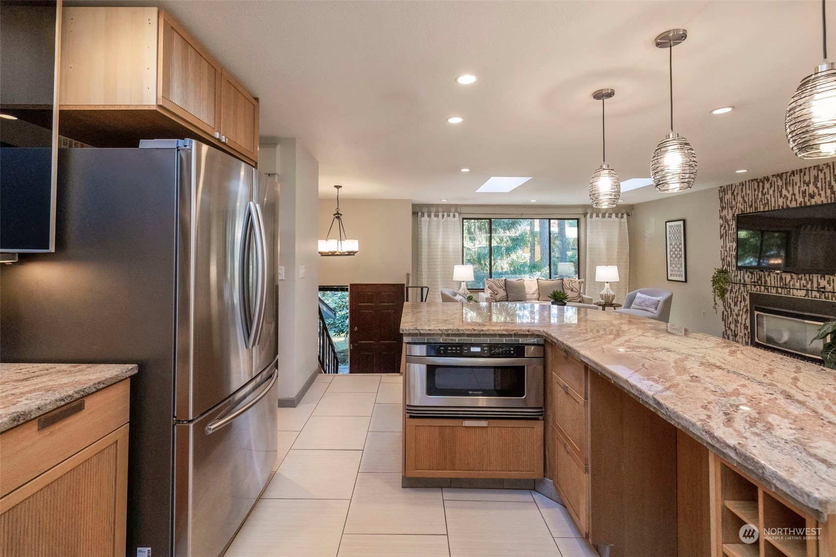5695 Southwest 44th Street Port Orchard, WA 98367 - Photo 13 of 40 a kitchen with stainless steel appliances granite countertop a refrigerator a stove and a sink