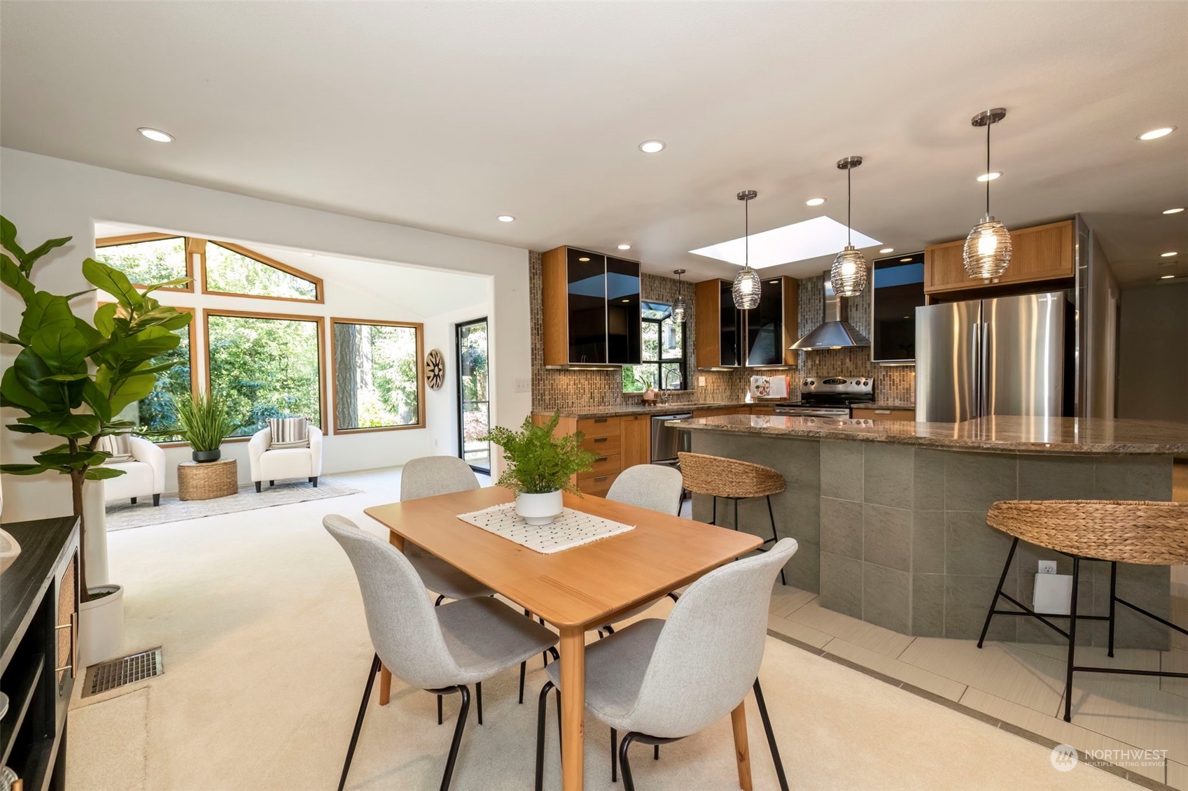 5695 Southwest 44th Street Port Orchard, WA 98367 - Photo 16 of 40 a dining area with a table chairs and a counter top space