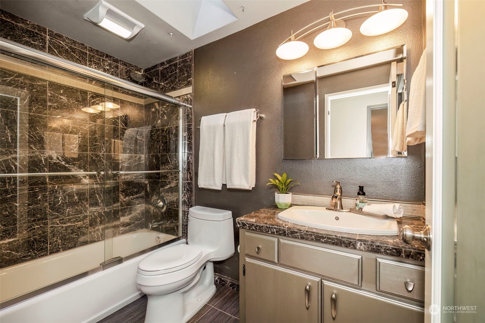 5695 Southwest 44th Street Port Orchard, WA 98367 - Photo 23 of 40 a bathroom with a granite countertop sink toilet and shower