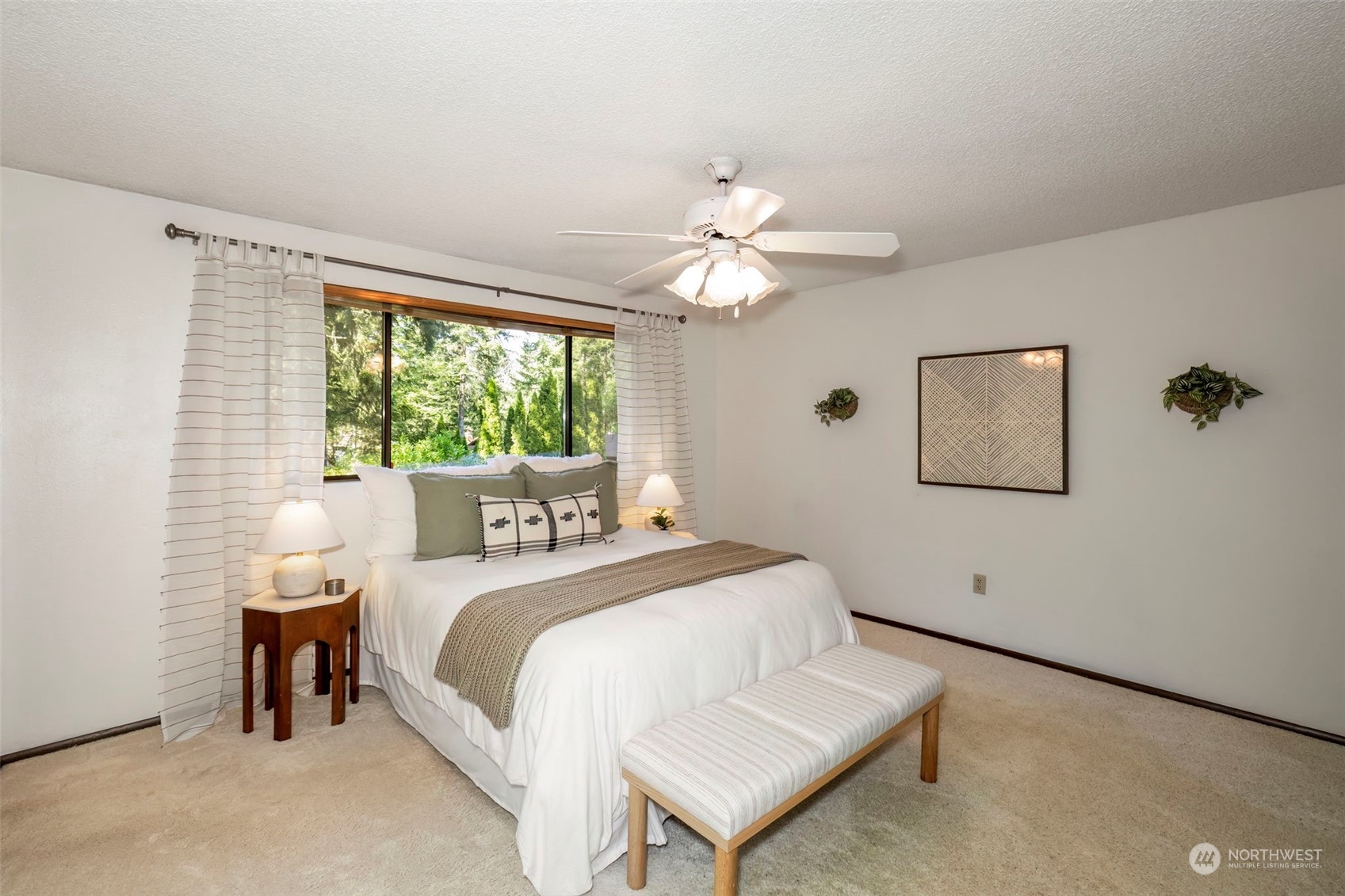 5695 Southwest 44th Street Port Orchard, WA 98367 - Photo 24 of 40 a bedroom with a bed and a chandelier
