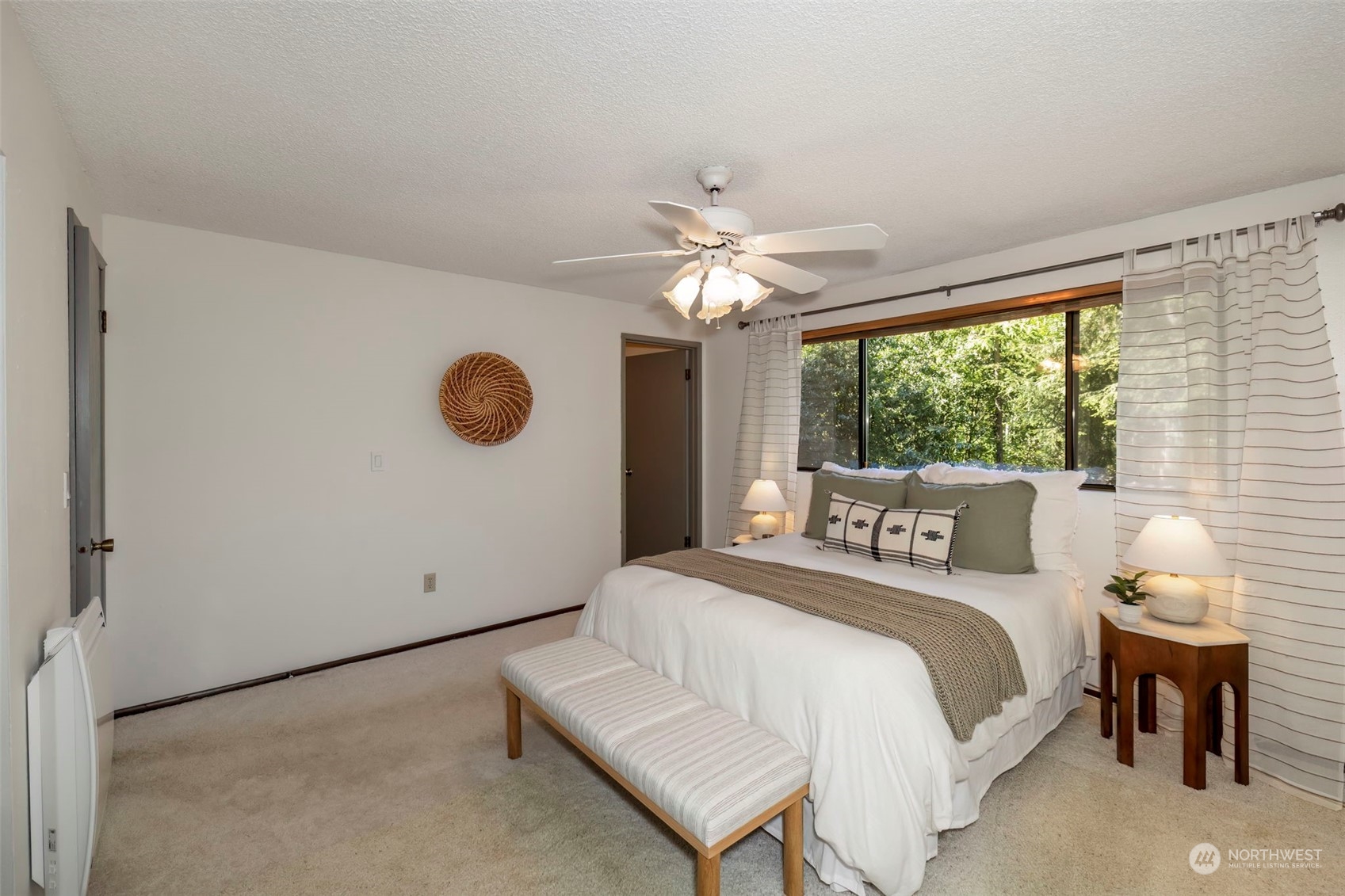 5695 Southwest 44th Street Port Orchard, WA 98367 - Photo 25 of 40 a bedroom with a large bed and a chandelier