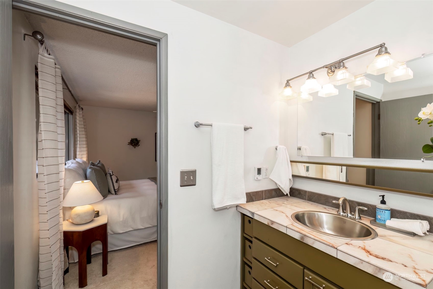 5695 Southwest 44th Street Port Orchard, WA 98367 - Photo 27 of 40 a en suite bathroom with a granite countertop sink and a mirror