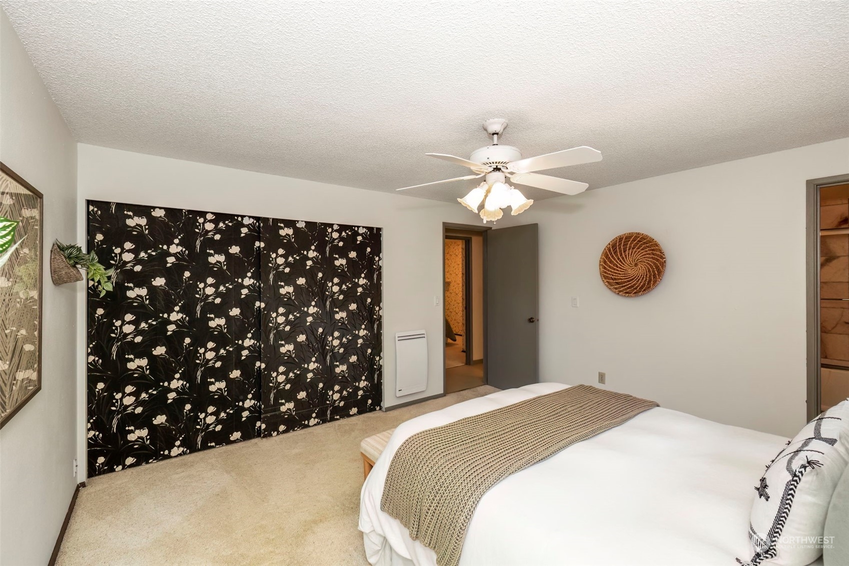 5695 Southwest 44th Street Port Orchard, WA 98367 - Photo 28 of 40 a bedroom with a large bed and a chandelier