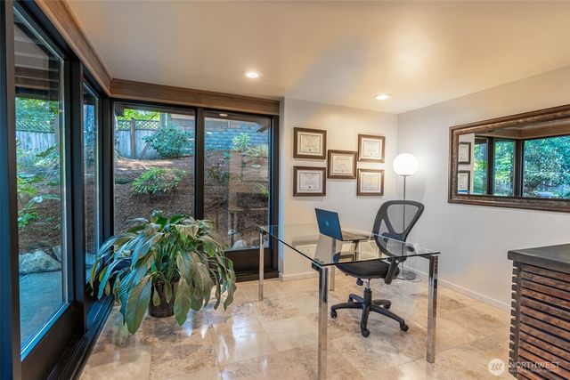 a view of balcony with chairs and wooden floor