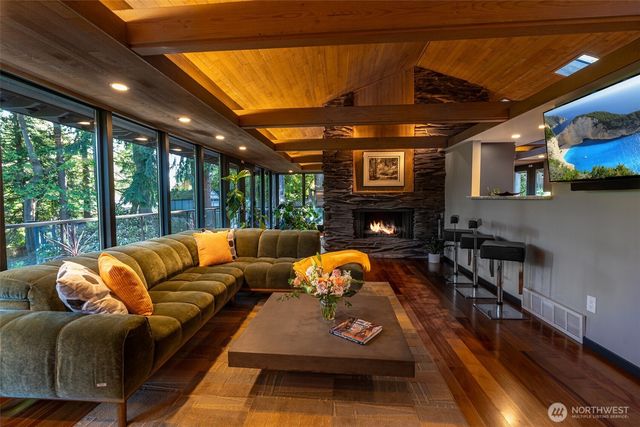 a living room with furniture a fireplace and a large window