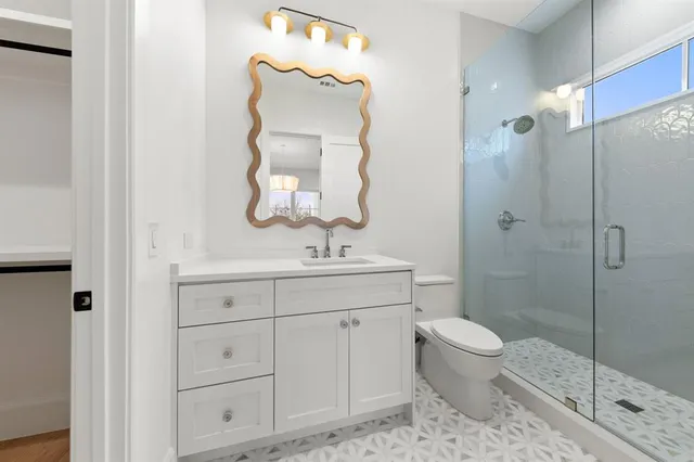 a bathroom with a toilet a sink a tub and mirror