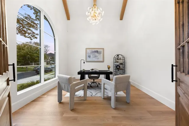 a dining room with wooden floor a glass table and chairs