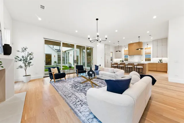 a living room with furniture and a chandelier