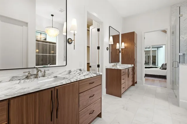 a spacious bathroom with a granite countertop sink mirror and a shower