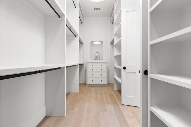 a view of walk in closet with white walls