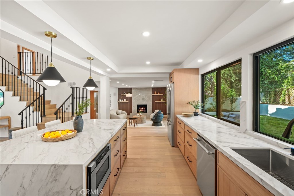 a view of a kitchen with a sink and a large window