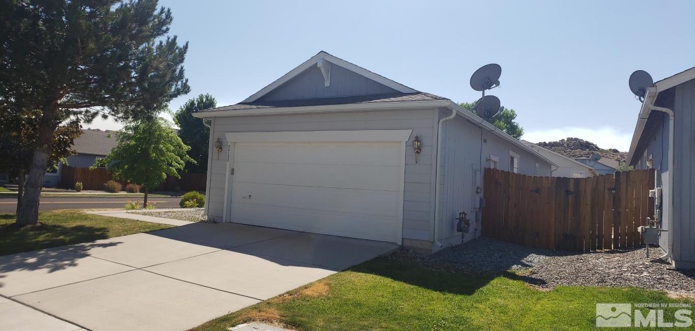 7752 Tulear Street Reno, NV 89506 - Photo 4 of 21 a front view of a house with a yard