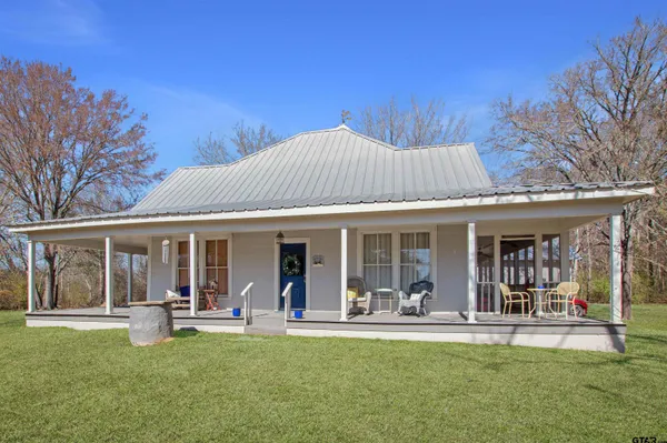 a front view of house with outdoor seating and yard