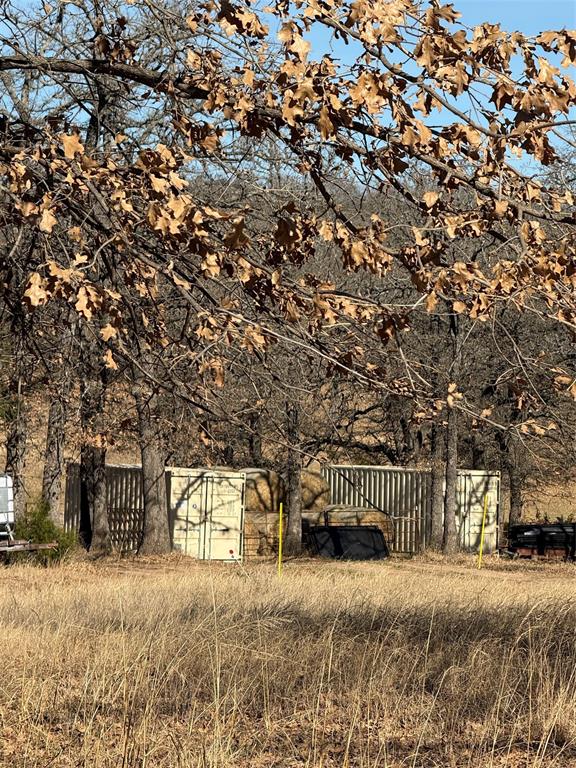 1072 3 Skillet Road Springtown, TX 76082 - Photo 9 of 12 a front view of a house with a yard and garage