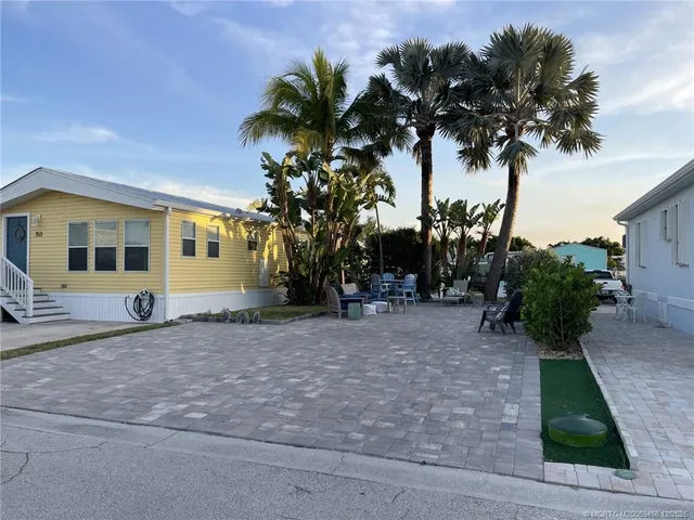 a view of a house with a tree in front