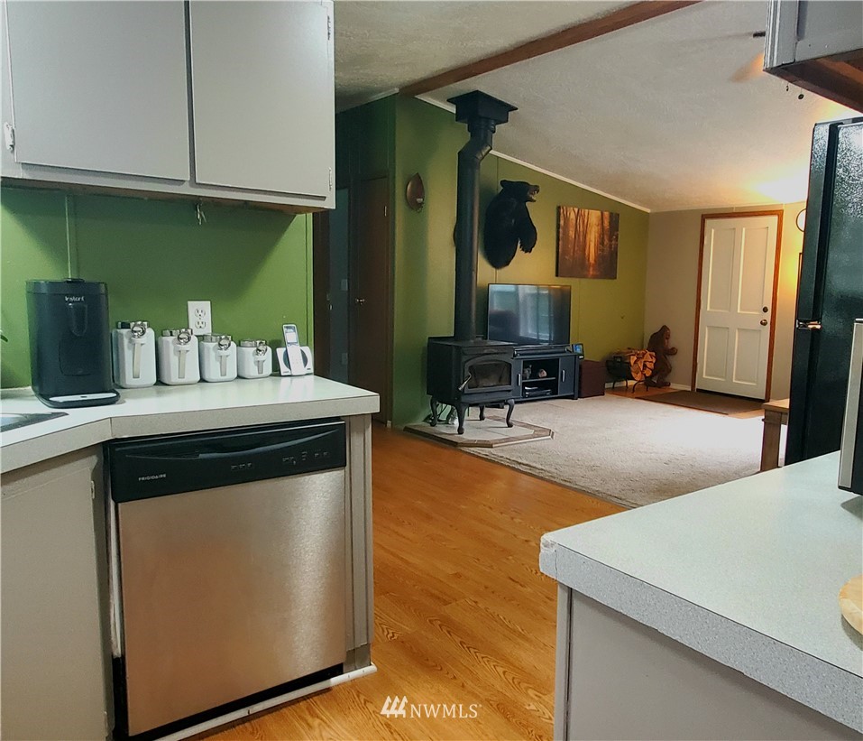 6851 South Pass Road Maple Falls, WA 98266 - Photo 17 of 34 a kitchen with stainless steel appliances granite countertop a sink and a refrigerator