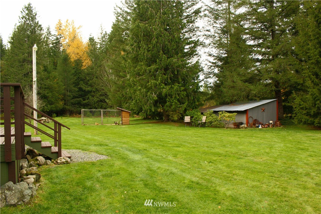 6851 South Pass Road Maple Falls, WA 98266 - Photo 10 of 34 a front view of a house with a yard and trees
