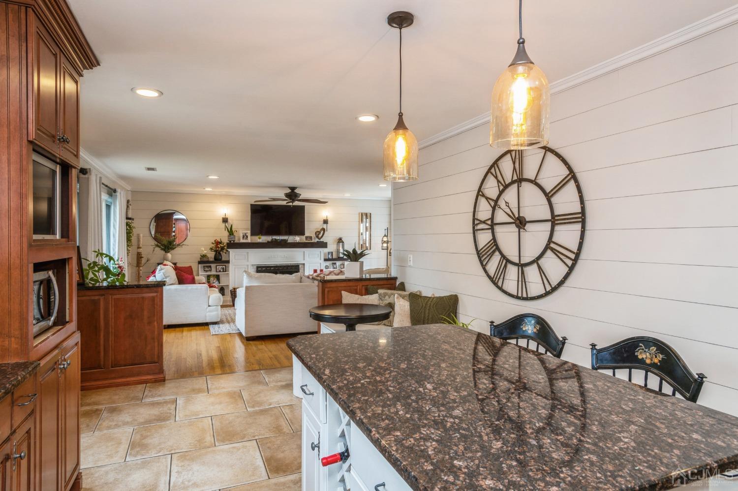 87 Stony Road Edison, NJ 08817 - Photo 6 of 26 a kitchen with stainless steel appliances granite countertop a sink a stove and a wooden floors