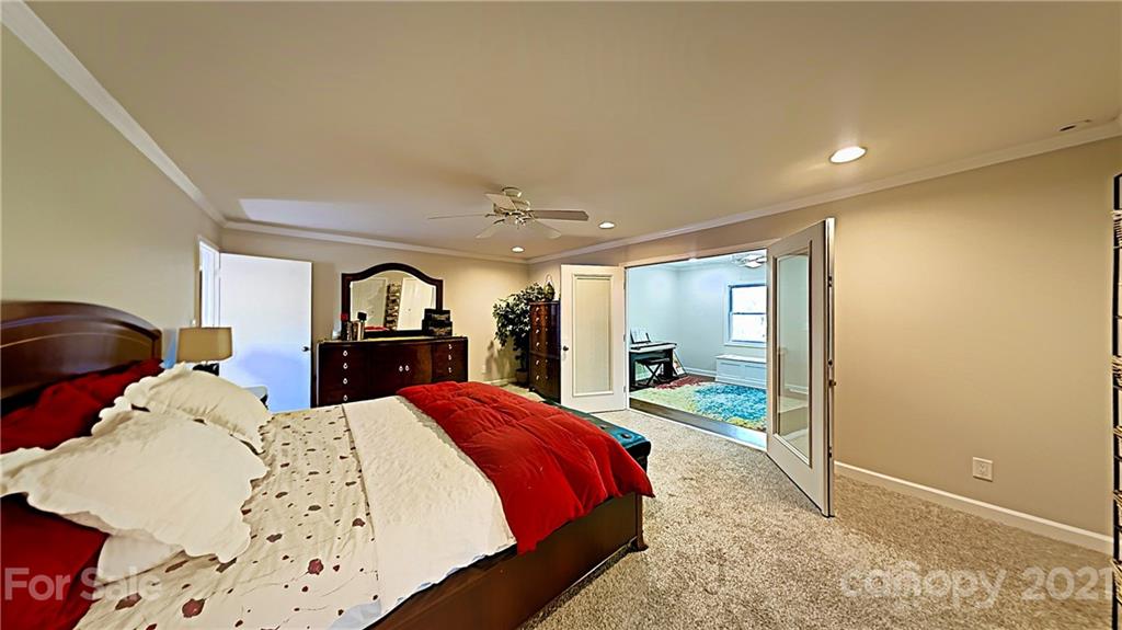 12 Duckhook Circle Lake Wylie, SC 29710 - Photo 14 of 30 a large bedroom with a large bed and dresser with mirror