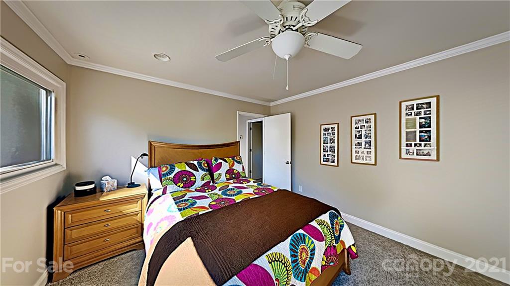 12 Duckhook Circle Lake Wylie, SC 29710 - Photo 20 of 30 a bedroom with a bed and a chandelier