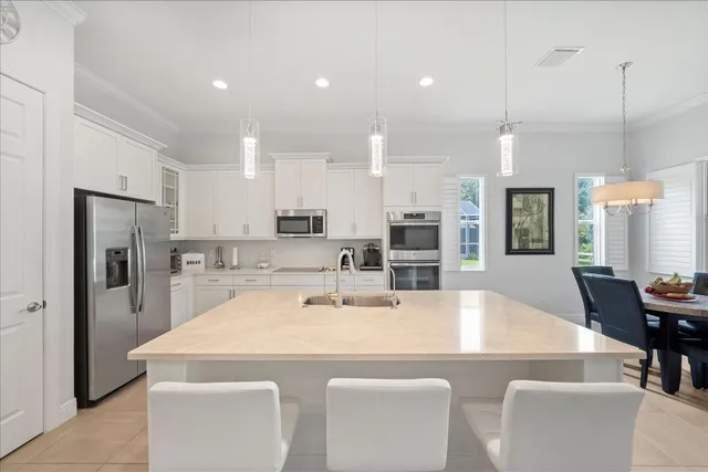 a view of kitchen with stainless steel appliances kitchen island wooden floor and refrigerator