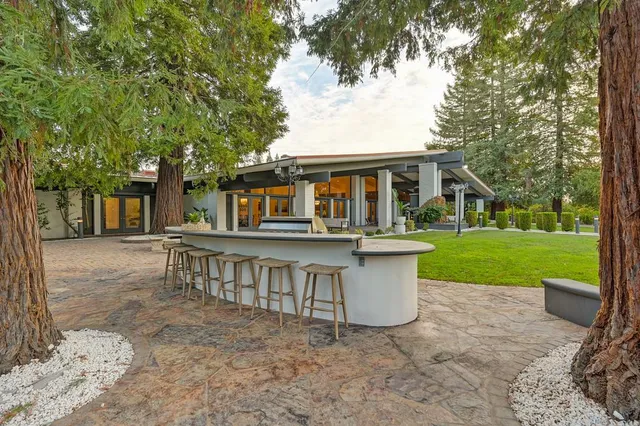 a view of a porch with a table and chairs