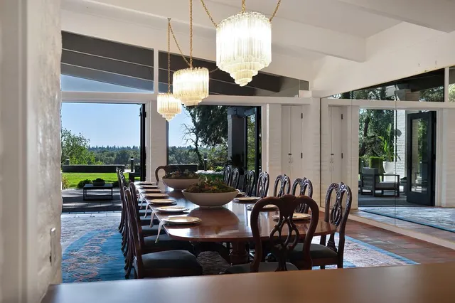 a bedroom with furniture and a large window
