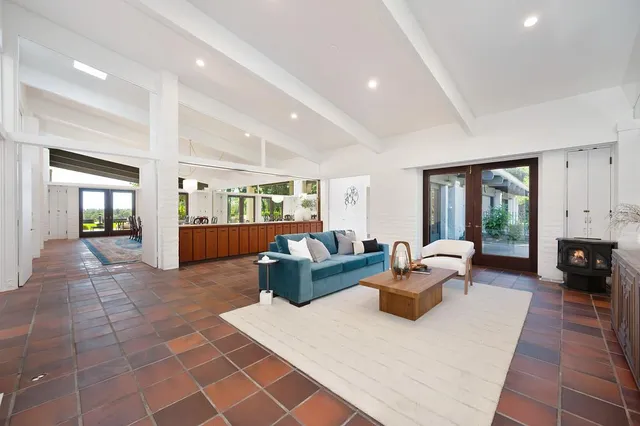 a bathroom with a granite countertop sink a large mirror and a bathtub