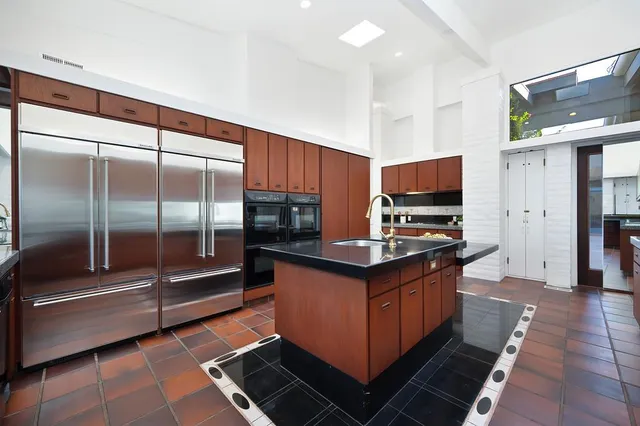 a view of a hallway to a livingroom with furniture