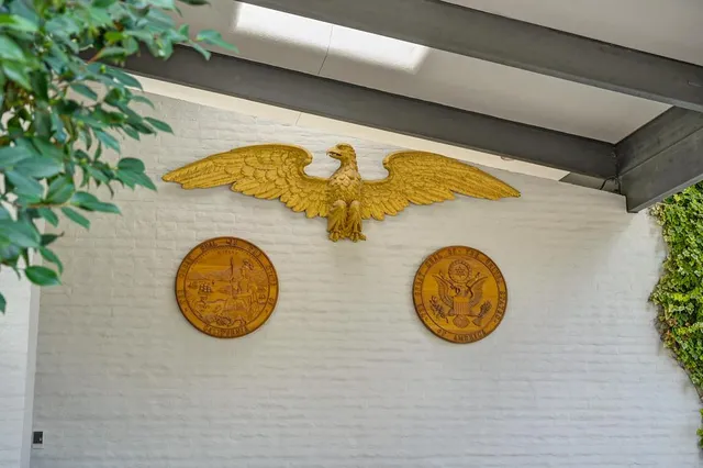 a front view of a house with a yard and fountain
