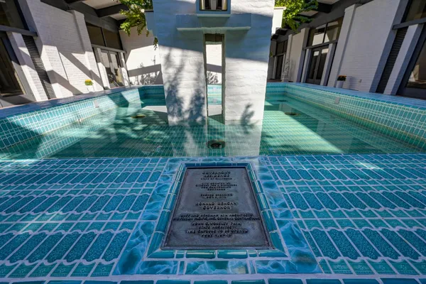 a view of house with backyard and outdoor seating