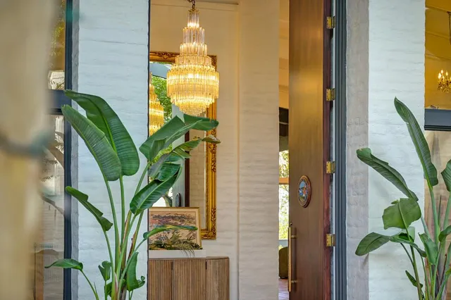 a backyard of a house with yard table and chairs