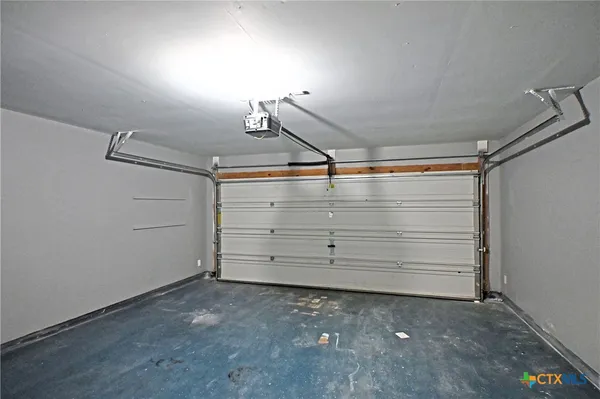 an empty room with stairs and windows