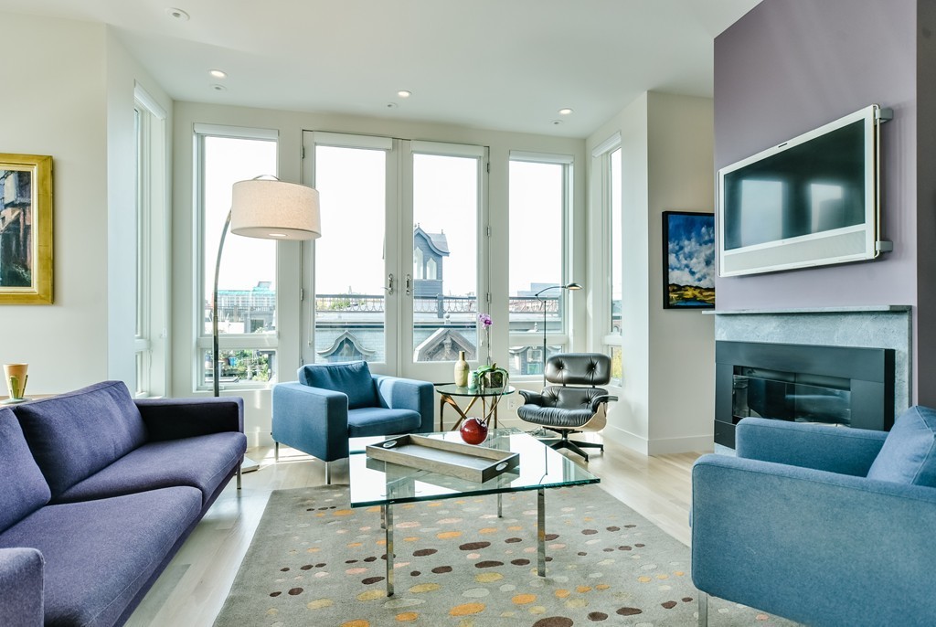 0 Worcester Square, Unit PH2 Boston, MA 02118 - Photo 2 of 18 a living room with furniture fireplace and a flat screen tv