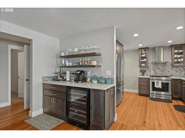 a kitchen with stainless steel appliances kitchen island granite countertop a stove a sink and a refrigerator