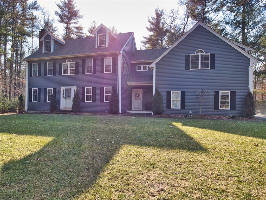 109 Haskell Ridge Road Rochester, MA 02770 - Photo 1 of 33 a view of a brick house next to a yard with big trees