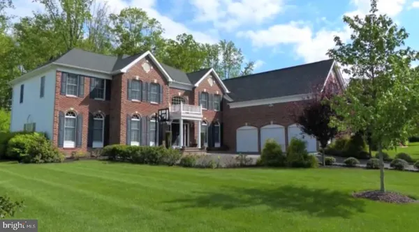 a front view of a house with a garden and plants